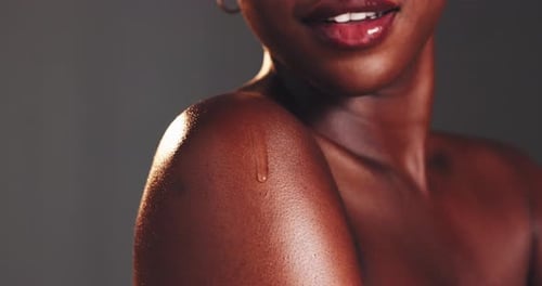 Studio, black woman and skincare with serum for shoulder, dermatology and clean shine for wellness