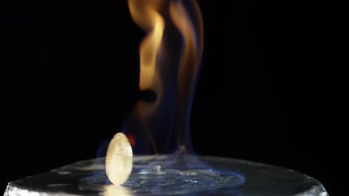 Bitcoin Spinning with Fire on Reflective Surface