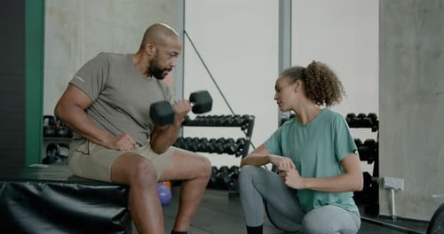 Fitness Instructor working with Client in Gym