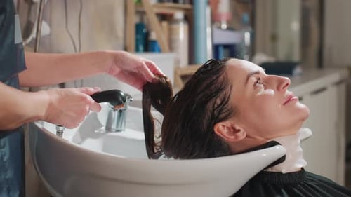 Woman Getting Hair Washed at Salon Hairdresser
