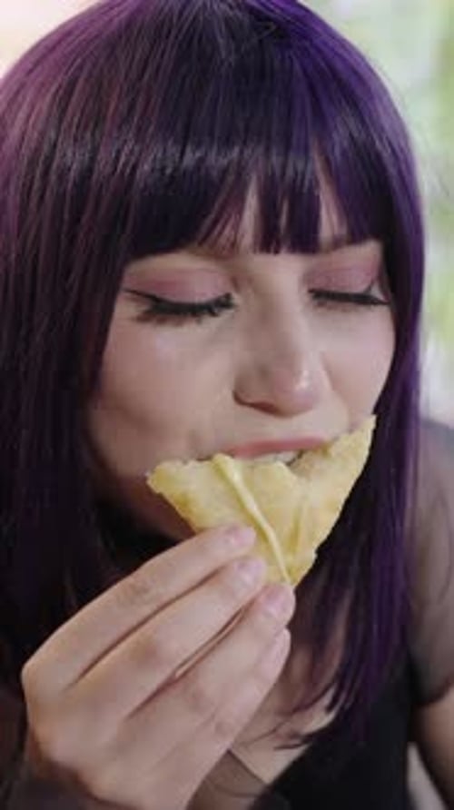 Woman Eating Cheesy Snack Food, Close Up Portrait