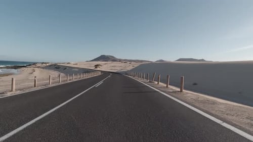 Driving through sand dunes by the sea