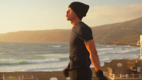 Young Adult Boxer Shadow Boxing at Sunset by Ocean