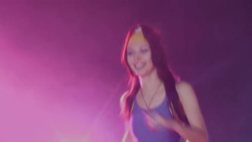 Woman Doing Step Aerobics in Studio with Pink Lighting