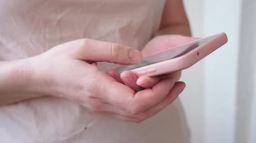 Woman's Hands Using Mobile Phone