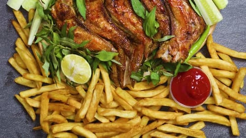 Grilled golden chicken wings surrounding crispy french fries, garnished with