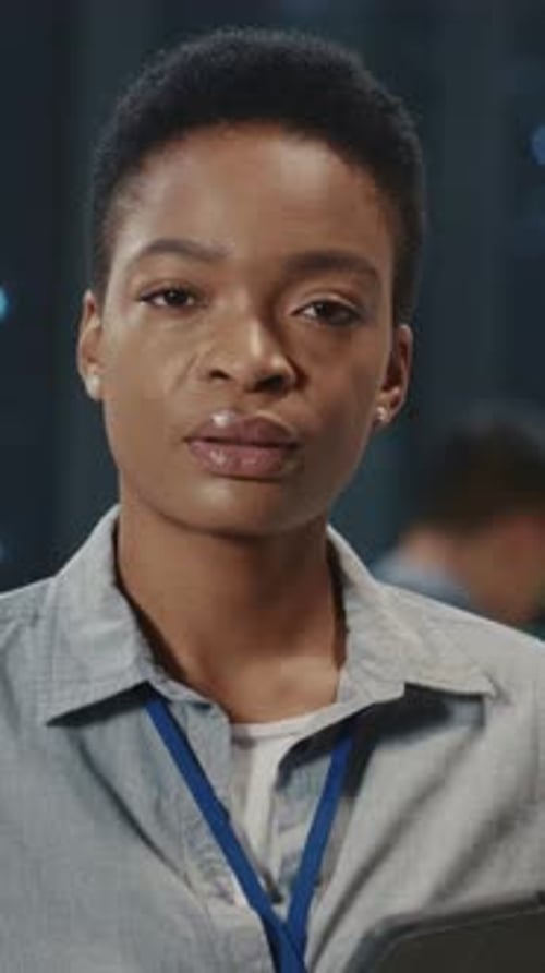 Young Woman in Data Center Looking at Camera