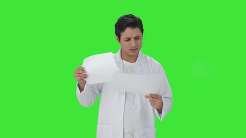 Confused Indian scientist reading research papers Green screen