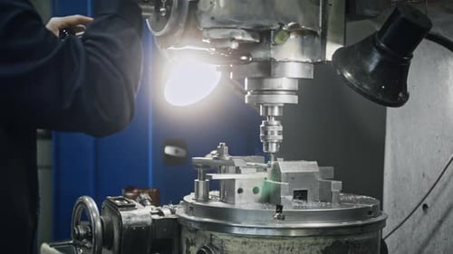 Industrial milling machine shaping metal workpiece with precision in workshop