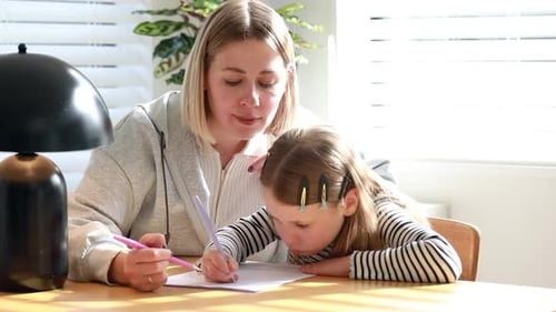 Mom Helps Her Daughter with Homework Teaches Writing Elementary School