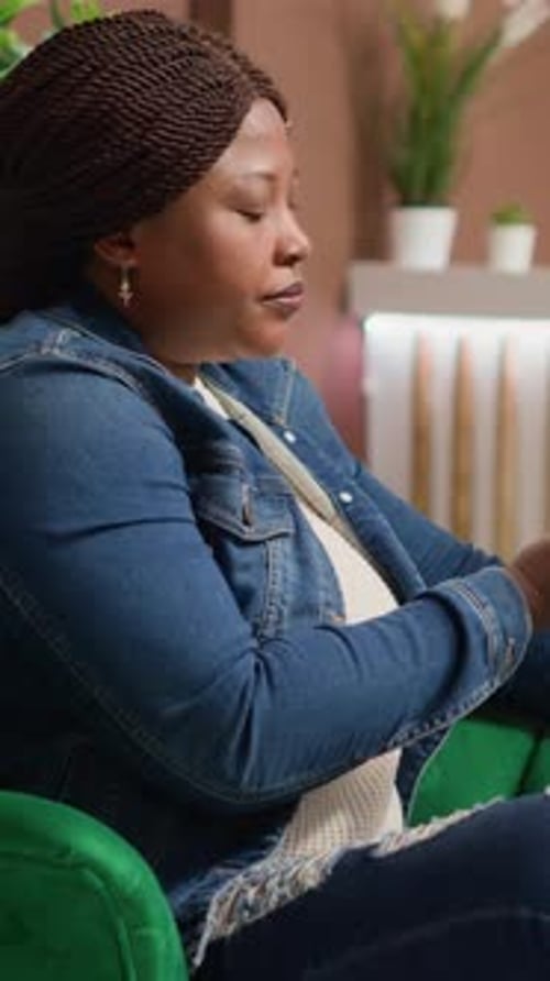 Woman Sitting, Using Phone in Home Interior