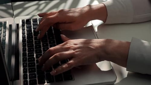 Woman's Hands Typing on Laptop Keyboard Close Up