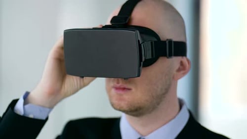 Man Wearing Virtual Reality Headset in Bright Office