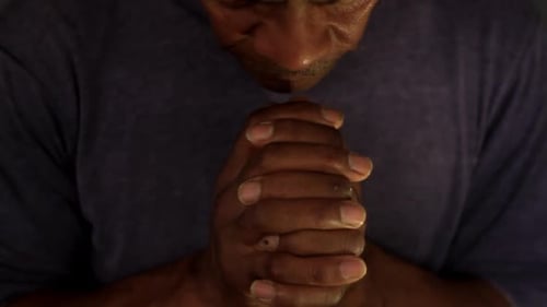 Man with Hands Clasped Together Praying