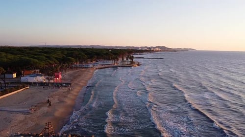 Aerial above beautiful coastline of Durres in Albania during sunset.