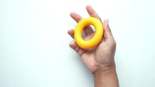Hand Squeezing Yellow Hand Grip Exerciser