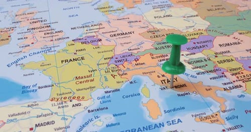 Italy - Travel concept with green pushpin on the world map. The location point on the map points to