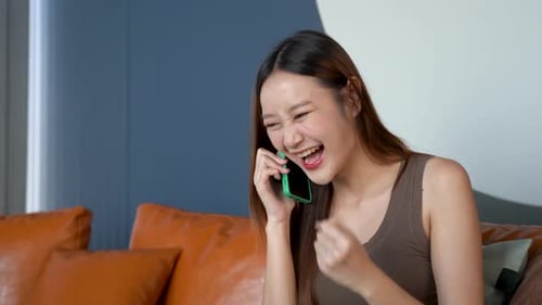 Excited Woman Celebrates Good News on Phone