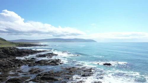 Aerial landscape rising over the shore line of the west coast of Scotland, shot on a bright sunny da