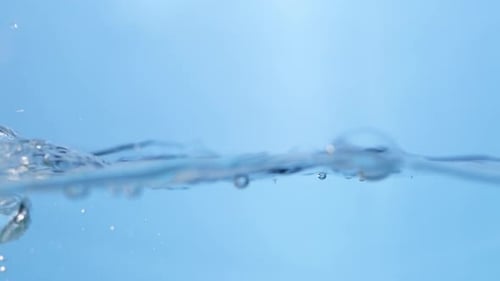 Slow Motion of a Water Drop Hitting the Surface. Photography of Liquid Motion.