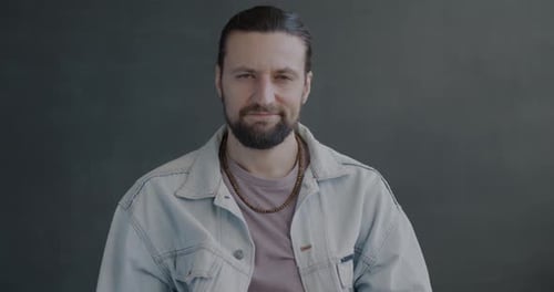 Slow Motion Portrait of Disappointed Guy Showing Thumbsdown Hand Gesture