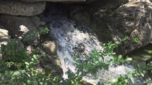 Small Waterfall Cascading Down Rocks in Nature