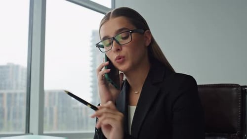 Professional Woman Talking on Phone in Modern Office