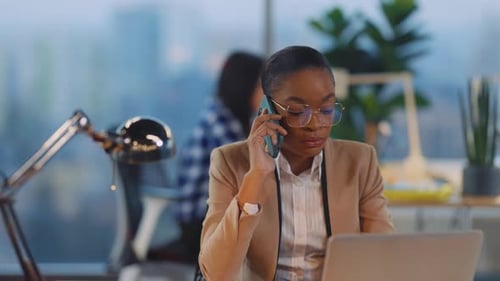 African American Woman Talking in Mobile Phone Answering Customer Questions Servicing Making Online