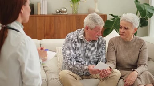 Female Doctor Examining Older Senior Couple in Doctor Office or at Home Old Woman Man Patient and