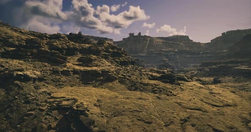 Rocky Terrain Under a Bright Cloudy Sky in a Remote Desert Landscape