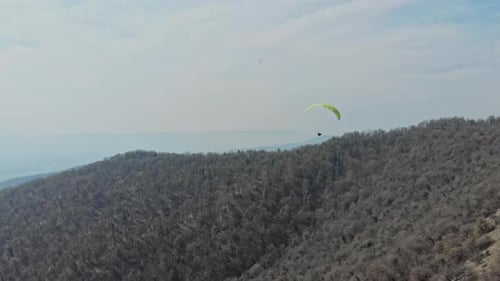 Experience the freedom of paragliding amidst breathtaking mountain vistas.