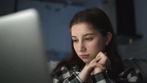 Attractive Young Girl Girl Watching Horrifying Footage On The Internet
