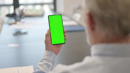 Senior Businessman Using Green Screen Phone