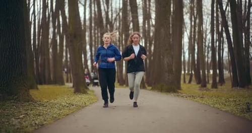 Two Woman Workout Exercising In Park Jogging Fitness