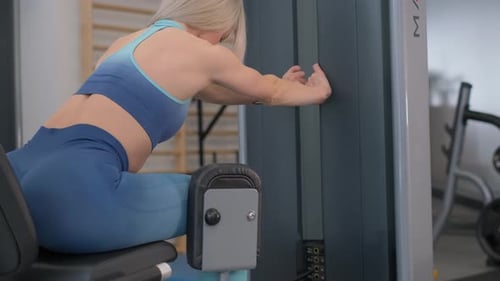 Athletic Woman Working Out in the Gym Dressed in Comfortable Sportswear