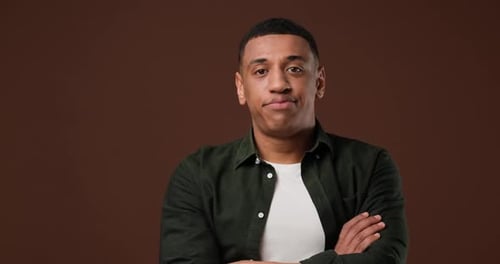 Disappointed Frustrated Young African Man Looking at Camera Exhales and Takes His Head in Despair