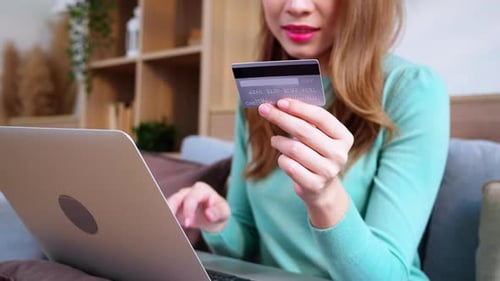 Woman Types Credit Card Info Into Laptop