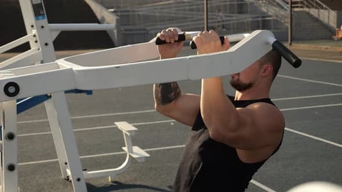 Man Doing Pull-ups at an Outdoor Gym