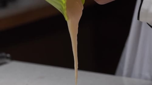 Chef Pouring Cake Batter into Baking Pan