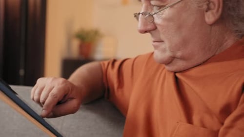 Older Man with Gray Hair Using Tablet Device