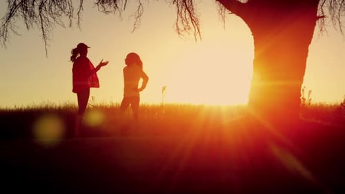Woman runner silhouette training on a vibrant track at sunrise near the sea