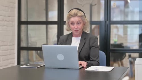 Professional Woman on a Video Call in Office