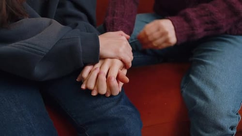 Closeup of Two Lesbian Women Family Couple Hold Caressing Hands Together Showing Love to Each Other