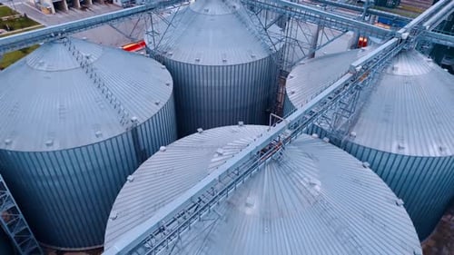 Metal tanks for processing and storing grain. Huge elevators at the agricultural plant.