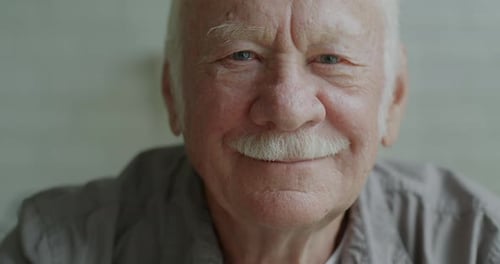 Senior Man Smiles Gently in a Close Up