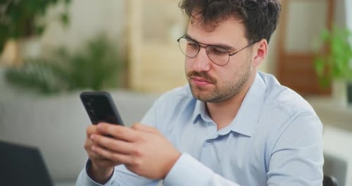 Adult Man Using Cell Phone at Home