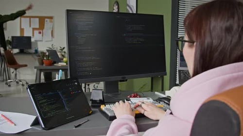 Female Developer Writing Algorithm Using Vibe Coding Assistant in Office