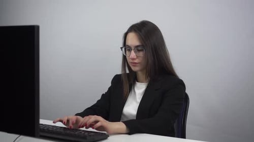 Businesswoman Works on a Computer in the Office