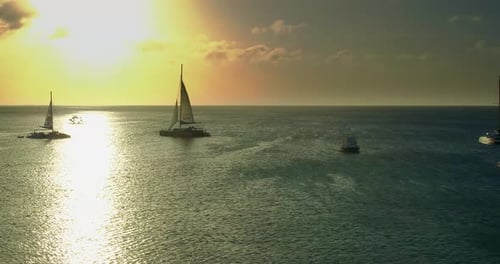 Palm Beach, Noord, Aruba - June 20 2016: Sailboats In Ocean Along Horizon At Sunset, Aerial Drone