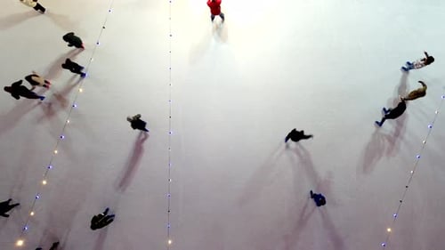 People Skating on Ice Skating Rink Outdoors Winter Night Top View